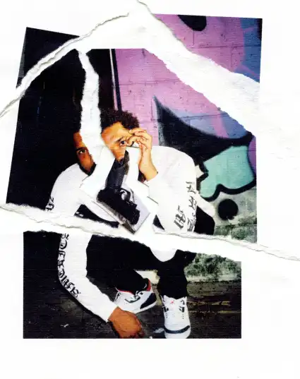 a ripped-style image of a guy sitting wearing white sneakers
