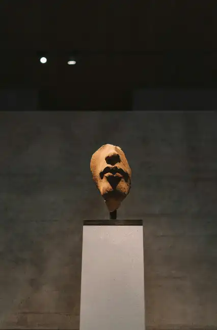 a face-shaped artwork mounted on top of an object